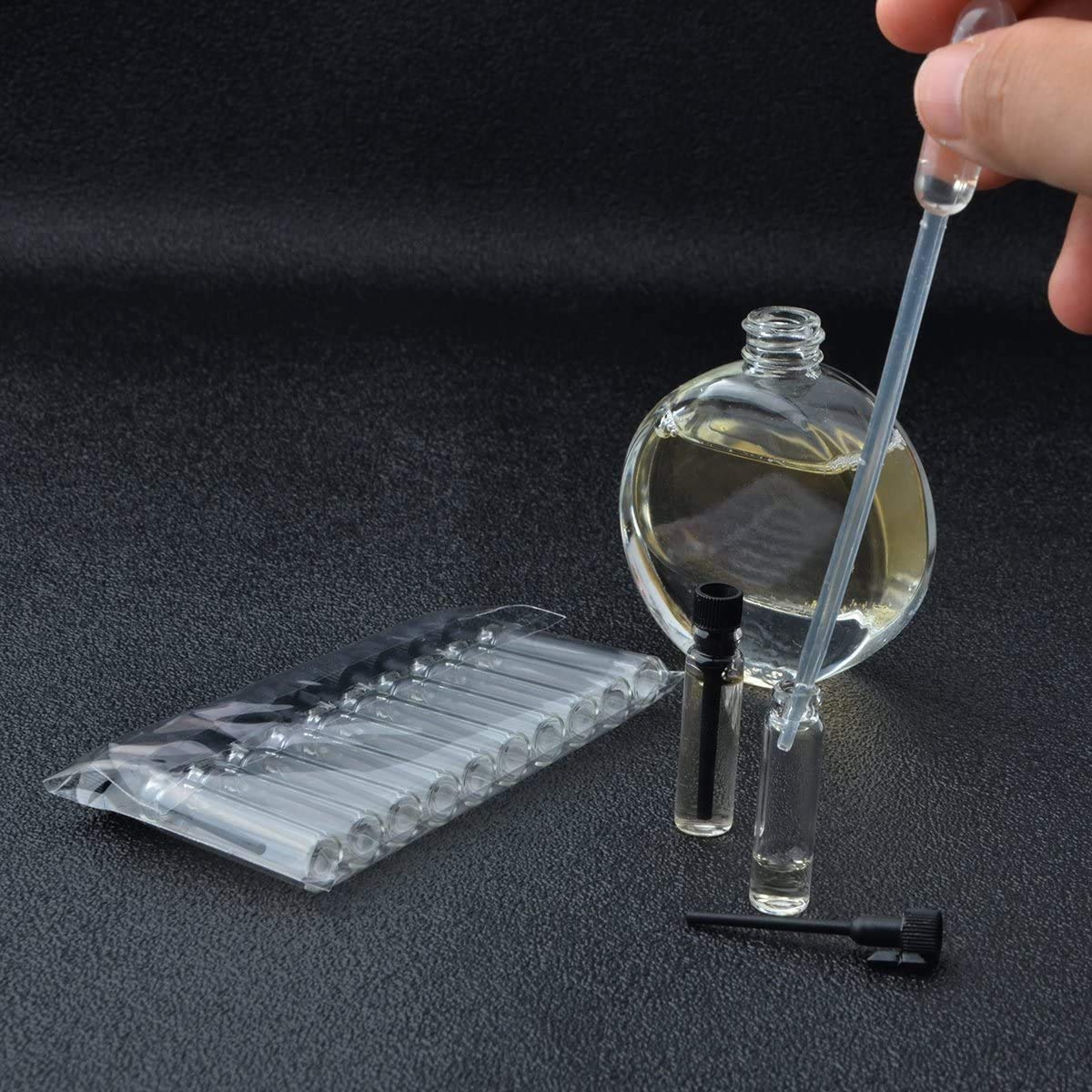 Enslz 100PCS Perfume Samples Mini Bottles With Black Lid Empty Glass Vials Dropper Bottle for Travel and Party(1ml)