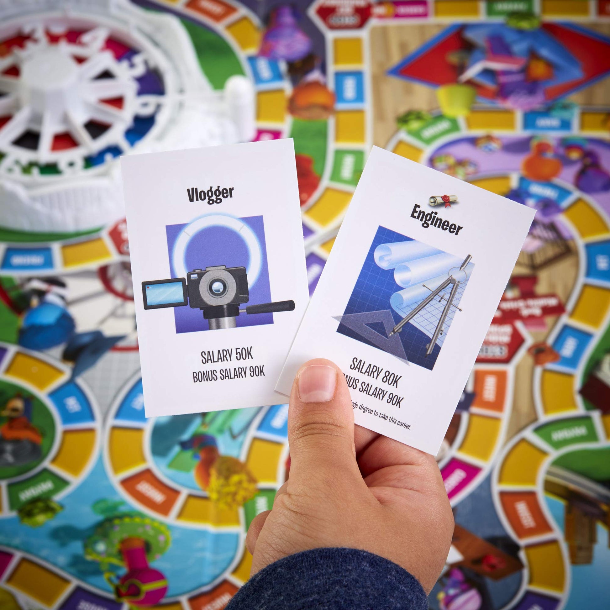 Hasbro Gaming The Game of Life, Juego de Mesa Familiar para 2 a 4 Jugadores, Juego de Interior para niños de 8 años en adelante, Clavijas Vienen en 6 Colores